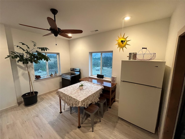 dining space with plenty of natural light, baseboards, visible vents, and light wood-type flooring