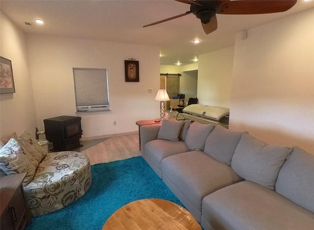 5355 Peaks View Dr, Helena, MT 59602 - living room featuring a wood stove, ceiling fan, wood finished floors, and recessed lighting