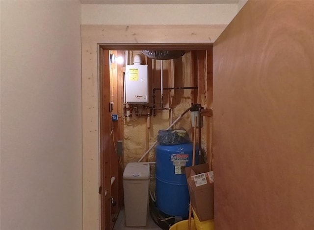 utility room featuring tankless water heater