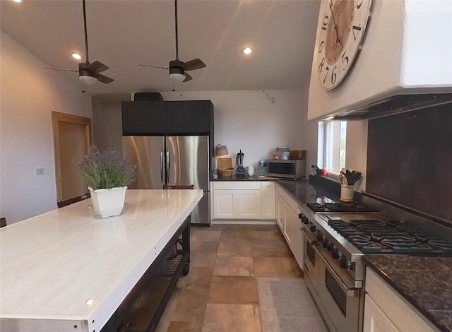 5355 Peaks View Dr, Helena, MT 59602 - kitchen featuring stainless steel appliances, wall chimney exhaust hood, a ceiling fan, lofted ceiling, and recessed lighting