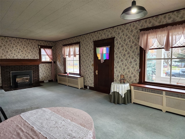 living room featuring a fireplace, carpet floors, and radiator