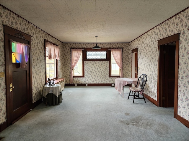 living area featuring carpet and ornamental molding