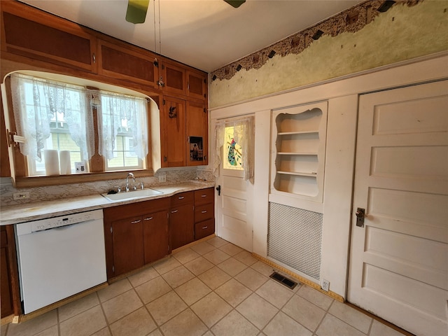 kitchen featuring dishwasher, light tile patterned flooring, sink, and ceiling fan