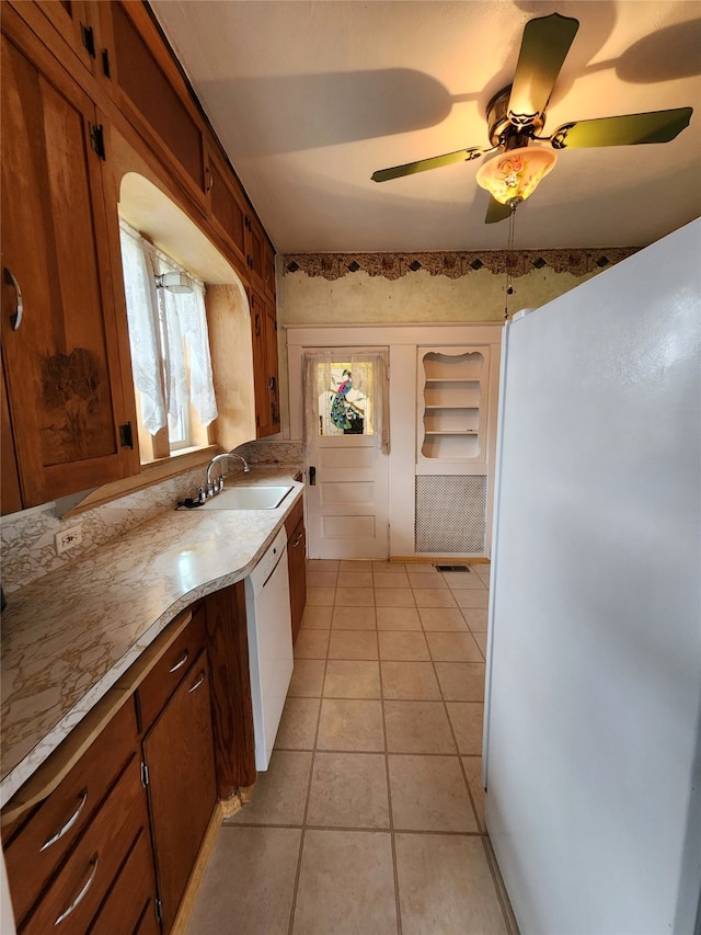 kitchen featuring ceiling fan, sink, white dishwasher, and light tile patterned flooring