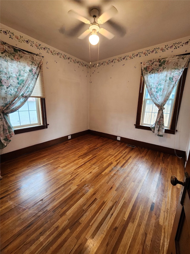 spare room featuring ceiling fan and hardwood / wood-style flooring