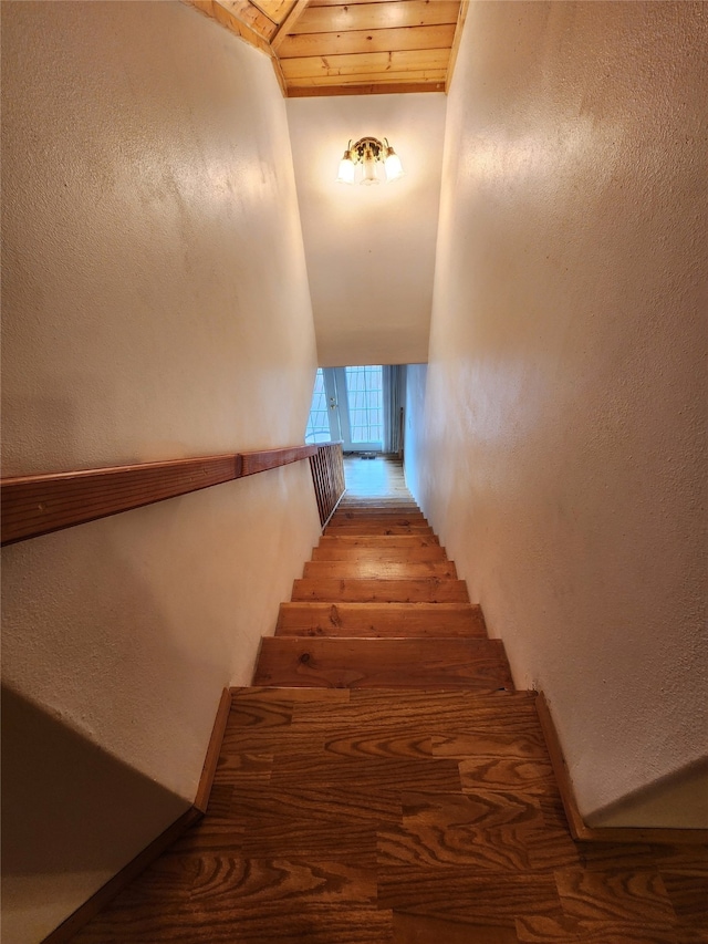 staircase with wooden ceiling