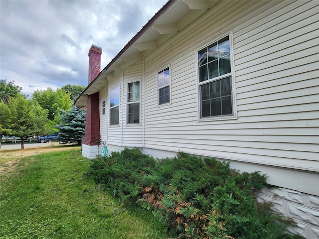 view of property exterior with a yard