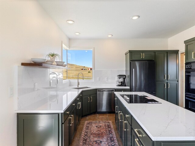 kitchen featuring decorative backsplash, light stone countertops, sink, black appliances, and dark tile patterned floors