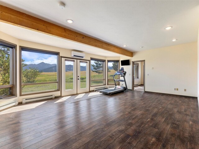 unfurnished living room with beam ceiling, hardwood / wood-style flooring, and plenty of natural light