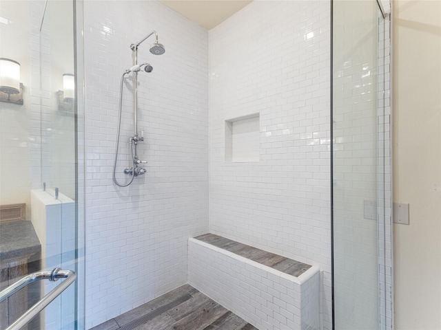 bathroom with hardwood / wood-style flooring and an enclosed shower