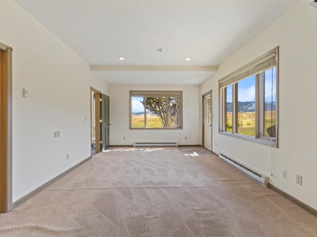 carpeted empty room featuring a baseboard radiator