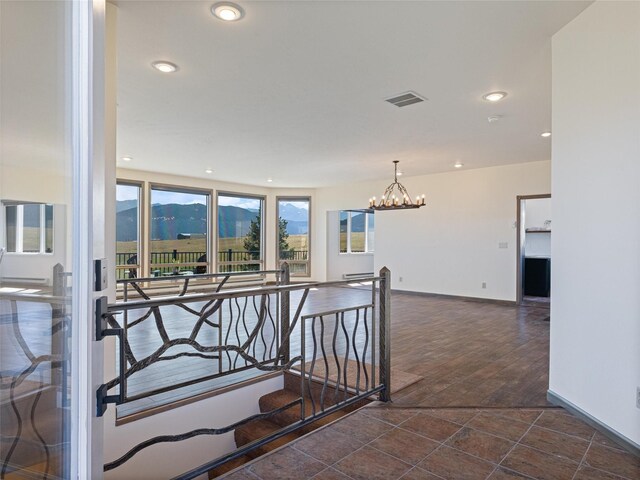 interior space featuring tile patterned floors, a notable chandelier, and a mountain view