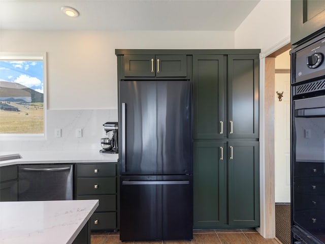 kitchen featuring tile patterned floors, backsplash, appliances with stainless steel finishes, and light stone countertops