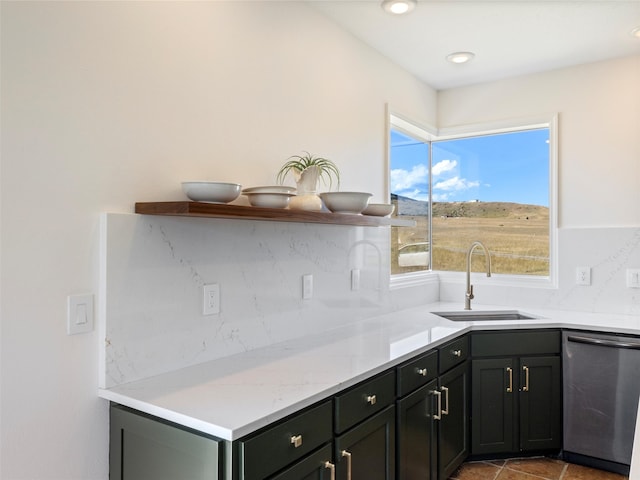 kitchen with light tile patterned flooring, sink, decorative backsplash, light stone counters, and stainless steel dishwasher