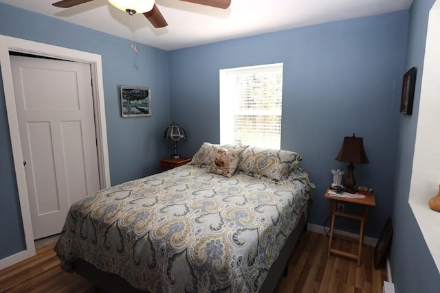 bedroom featuring ceiling fan, baseboards, and wood finished floors