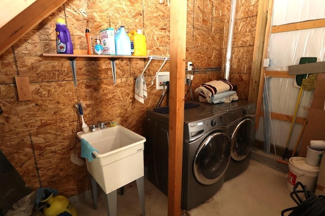 laundry room with a sink, laundry area, and washing machine and clothes dryer