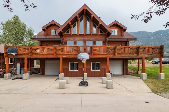 view of front of property with a garage and a deck with mountain view