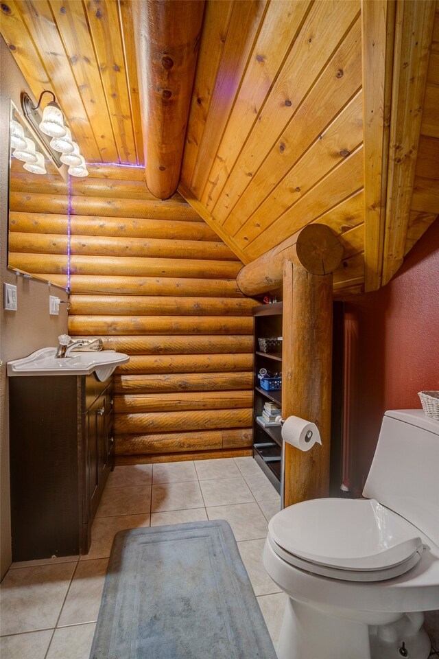 bathroom with toilet, tile patterned flooring, vanity, rustic walls, and wood ceiling