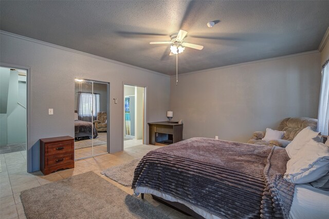 bedroom featuring ornamental molding, a textured ceiling, light tile patterned floors, and ceiling fan