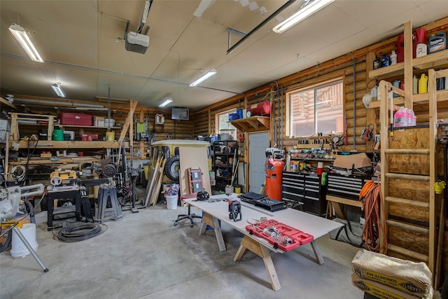 garage featuring a garage door opener and a workshop area