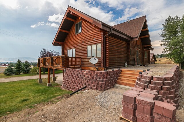 view of home's exterior with a yard and a deck