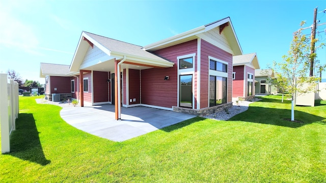 view of property exterior with central AC and a yard