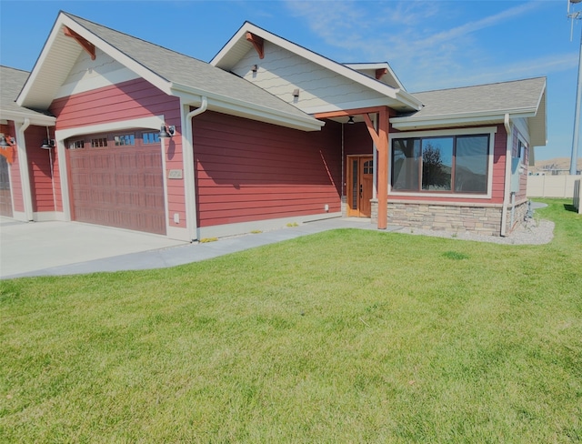 view of front of home featuring a garage and a front lawn