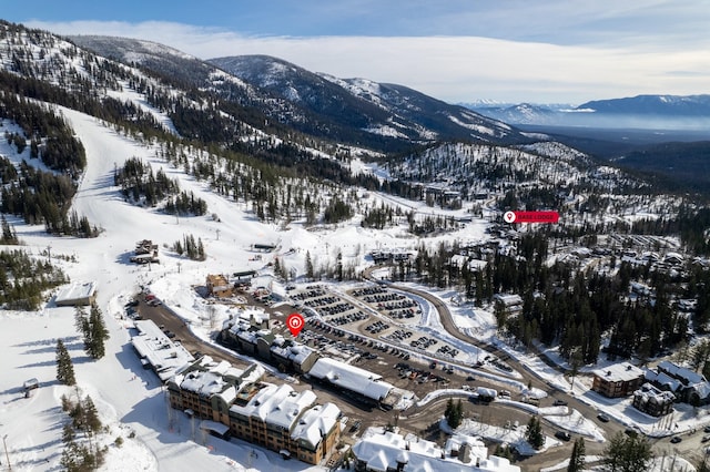 snowy aerial view with a mountain view