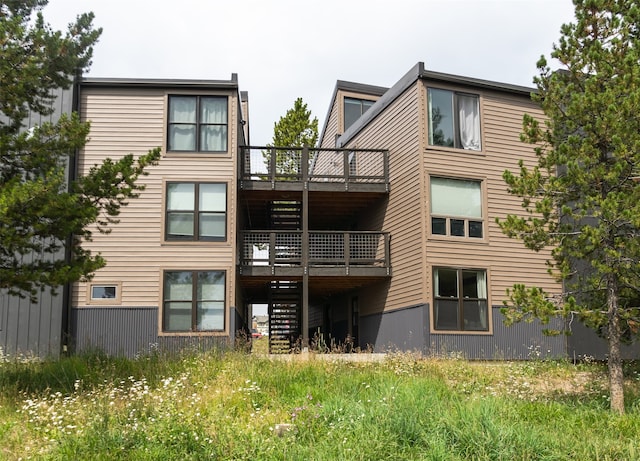 rear view of property featuring a balcony