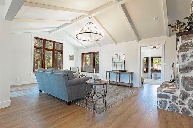 living room with beamed ceiling, hardwood / wood-style flooring, a notable chandelier, and high vaulted ceiling