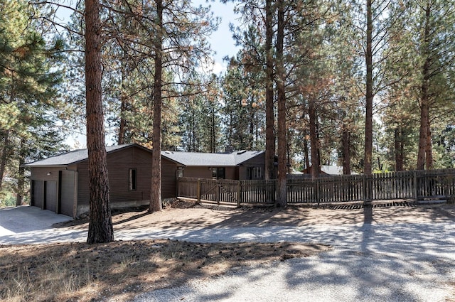 215 Hilltop Dr, Hamilton, MT 59840 - view of property exterior with a garage, concrete driveway, and fence