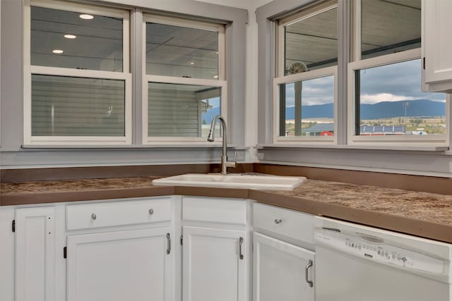 kitchen featuring white cabinetry, a mountain view, sink, and dishwasher