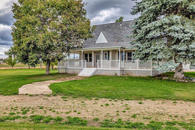 farmhouse inspired home featuring a front yard and covered porch