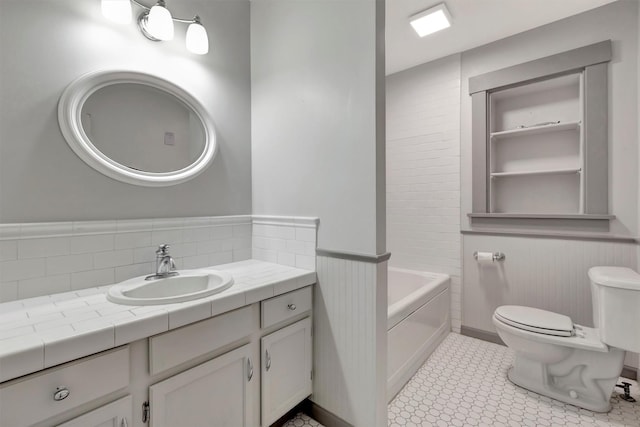 bathroom featuring vanity, a bathing tub, and toilet