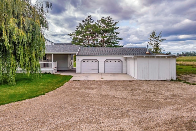 ranch-style house with a garage, a porch, and a front yard