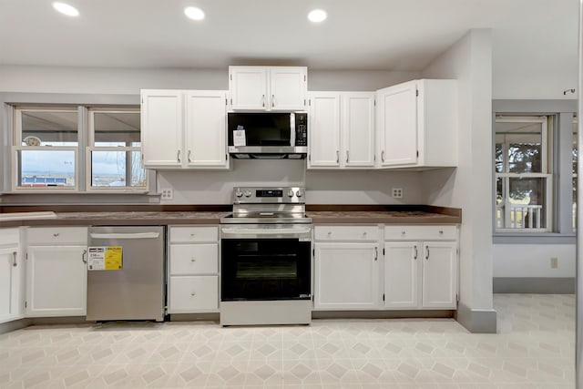 kitchen featuring white cabinetry and appliances with stainless steel finishes