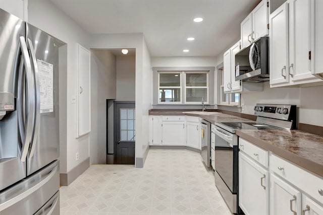 kitchen featuring sink, white cabinets, and appliances with stainless steel finishes