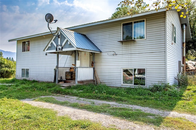 back of house with a lawn