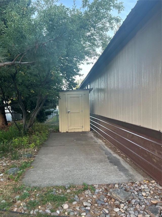 view of side of property with a storage unit