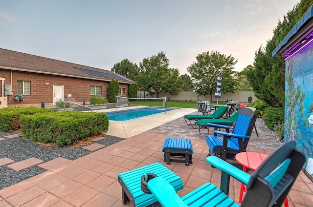 view of pool featuring outdoor dining space, a patio area, and a fenced backyard