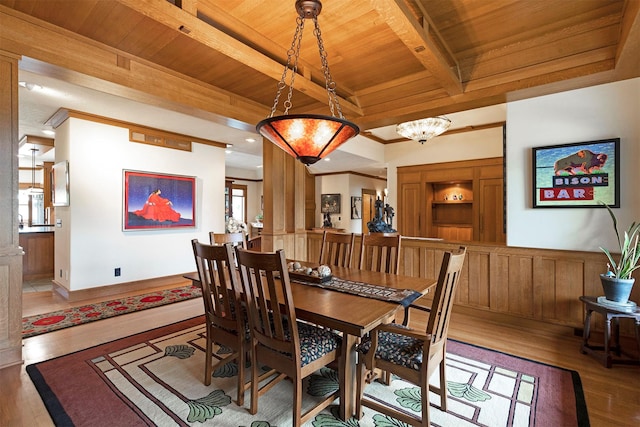 dining area with wood ceiling, ornamental molding, beamed ceiling, wood finished floors, and an inviting chandelier