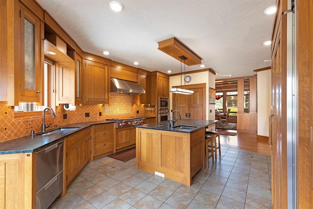 kitchen featuring dark countertops, a sink, and wall chimney exhaust hood