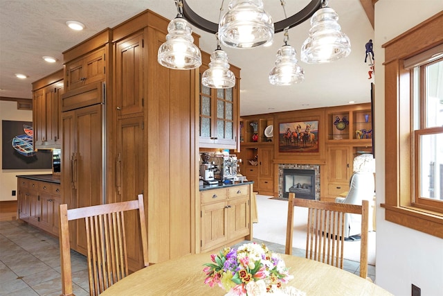 dining space featuring recessed lighting, a fireplace with flush hearth, built in features, and light tile patterned flooring