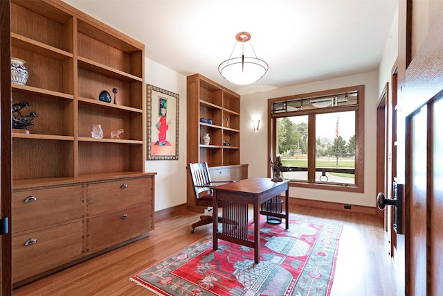 office area featuring light wood-type flooring and baseboards