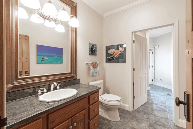 bathroom with baseboards, vanity, toilet, and crown molding