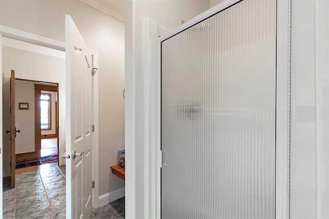 bathroom with crown molding and baseboards