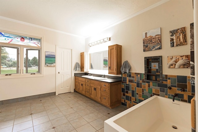 bathroom with ornamental molding, tile patterned flooring, a bathtub, and a sink