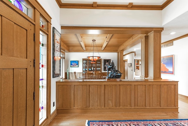 foyer with light wood-type flooring, crown molding, decorative columns, and wooden ceiling