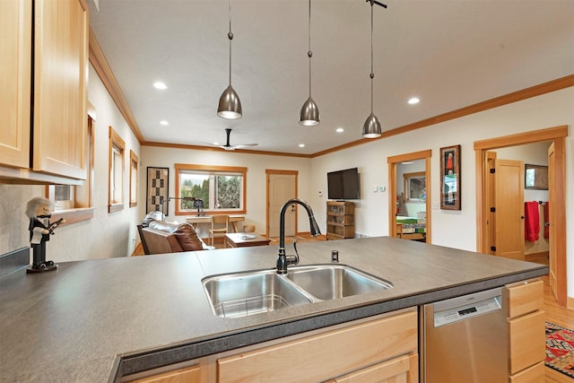 kitchen with dark countertops, stainless steel dishwasher, light brown cabinetry, open floor plan, and a sink