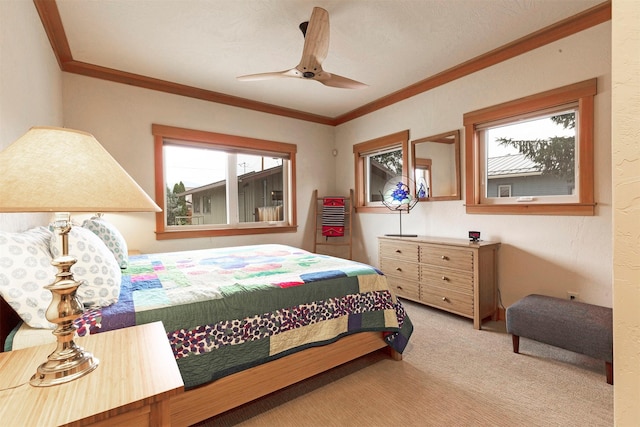 bedroom featuring crown molding, a ceiling fan, and carpet flooring